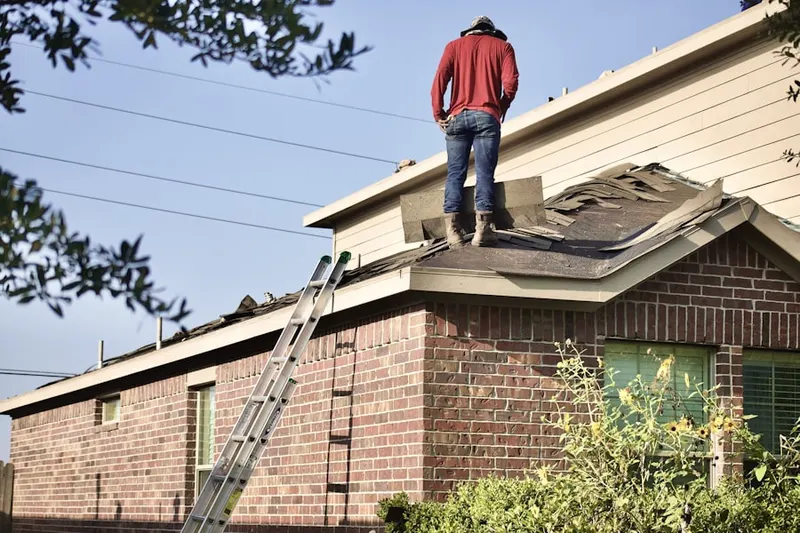 Professional roofer working on a residential roof in Churchton